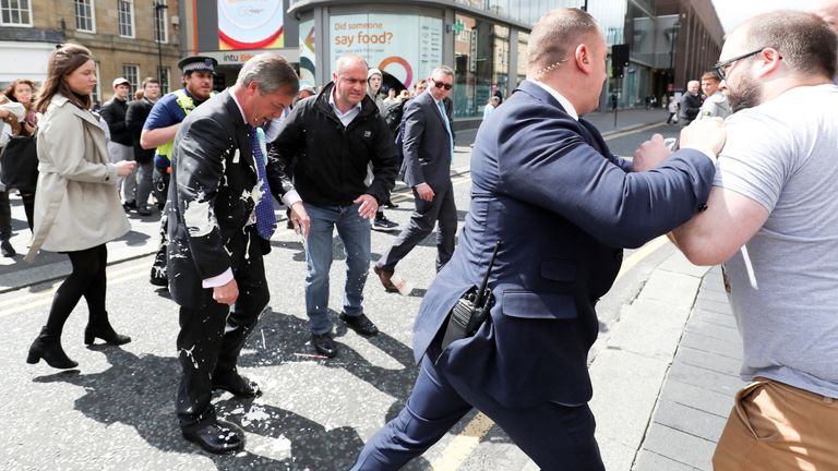 Brexit Party leader Nigel Farage  gestures after being hit with a milkshake while arriving for a Brexit Party campaign event in Newcastle, Britain, May 20, 2019. REUTERS/Scott Heppell

