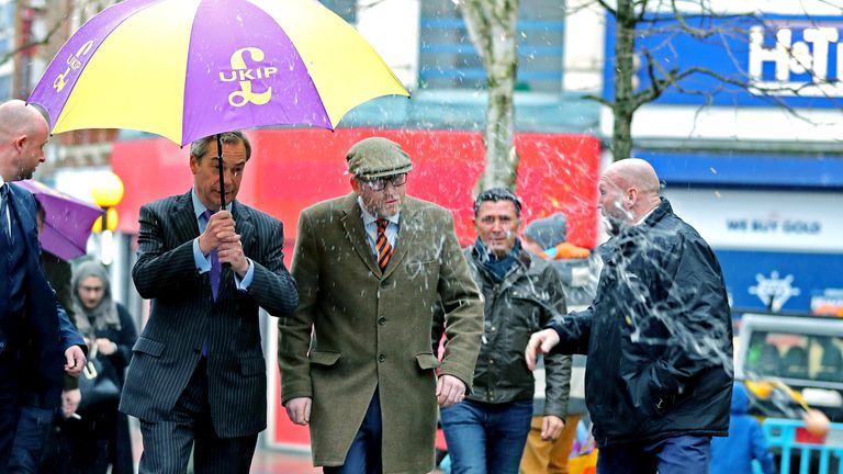 A youth (not pictured) throws eggs at former Ukip leader Nigel Farage (centre left), as he greets Ukip leader Paul Nuttall (centre right) near to Paul's campaign office in Stoke-on-Trent, Staffordshire.