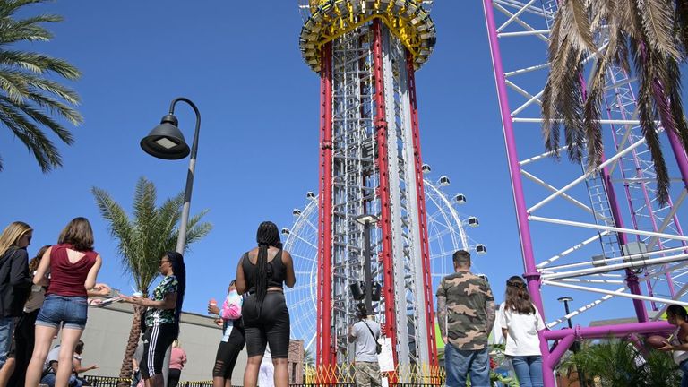 People visit a makeshift memorial for Tyre Sampson outside the Orlando Free Fall ride at the ICON Park entertainment complex, Sunday, March 27, 2022, in Orlando, Fla. Sampson, a teenager visiting from Missouri on spring break, fell to his death while on the ride. (Phelan M. Ebenhack via AP)


