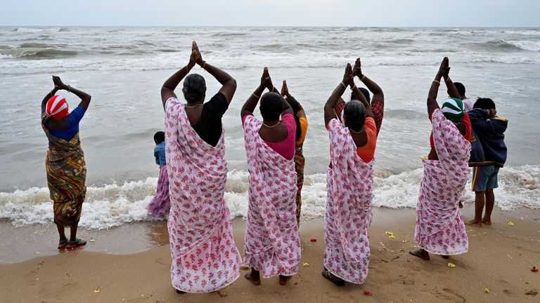 People scatter flower petals after pouring milk into the Bay of Bengal as a gesture of respect to the victims of the 2004 Indian Ocean Tsunami on the 20th anniversary of the disaster, at Marina Beach in Chennai, India.
Pic: Reuters