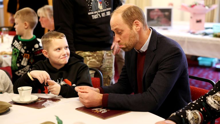 The Prince of Wales reacts as he looks at a portrait drawn by Karson Heighway.
Pic: PA