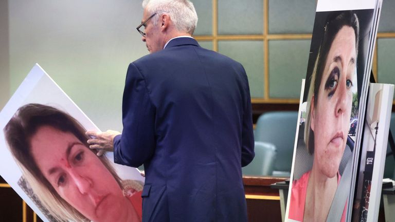 Defense counsel James Owens addresses circuit judge Michael Kraynick with photos of Sarah Boone, charged with second-degree murder in the 2020 death of her boyfriend , he planned to use in opening statements on the first day of Boone's trial in Orange circuit court in Orlando, Fla., Friday, Oct. 18, 2024.   (Joe Burbank/Orlando Sentinel via AP)