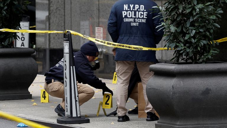 Members of the NYPD Crime Scene Unit work near evidence markers placed where shell casings were found at the scene.
Pic Reuters