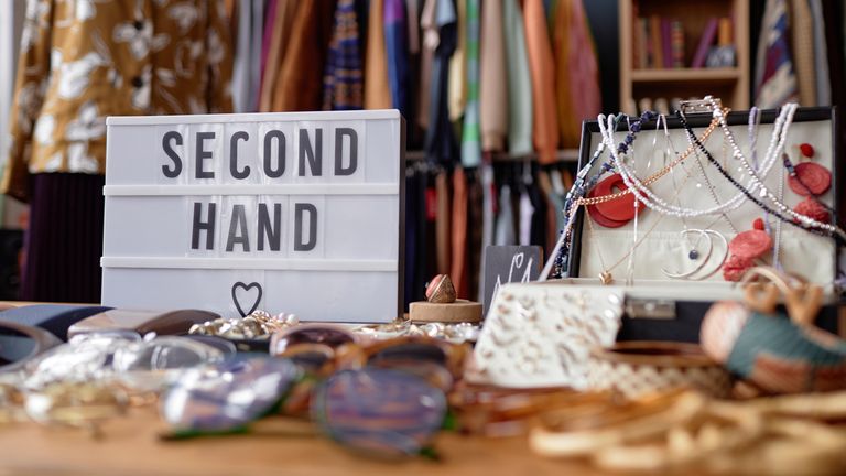 Close up on sign with inscription Second Hand and jewellery case with vintage accessories at thrift store checkout, copy space Pic: iStock