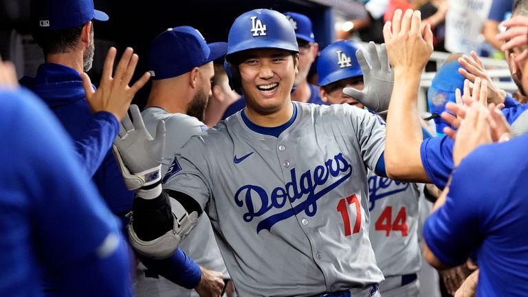 FILE - Los Angeles Dodgers' Shohei Ohtani (17) celebrates in the dugout after hitting a home run during the sixth inning of a baseball game against the Miami Marlins, Thursday, Sept. 19, 2024, in Miami. (AP Photo/Marta Lavandier, File)