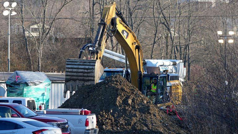 Rescue workers search for Elizabeth Pollard, who is believed to have disappeared in a sinkhole while looking for her cat. Pic: AP