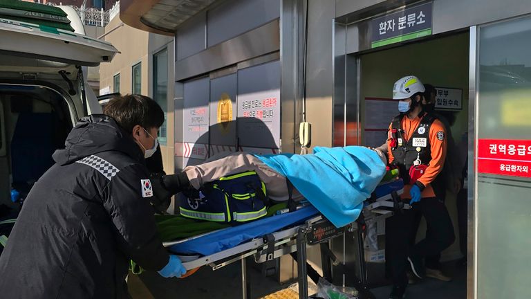 A person rescued from the plane crash is rushed to a hospital in Mokpo.
Pic: Cho Geun-young/Yonhap/AP)