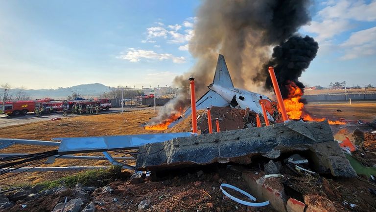 The passenger plane in flames in the immediate aftermath of the crash.
Pic: South Korea's Muan Fire Station/AP