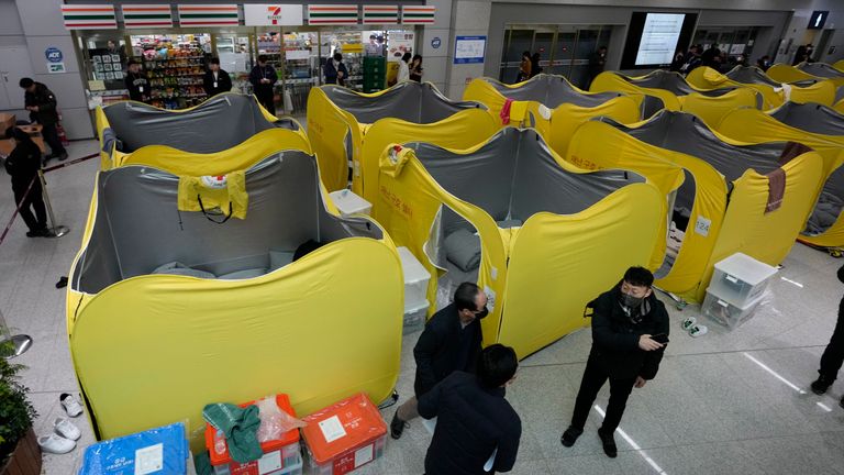 Temporary shelters set up at the airport for mourners waiting for answers.
Pic: AP/Ahn Young-joon