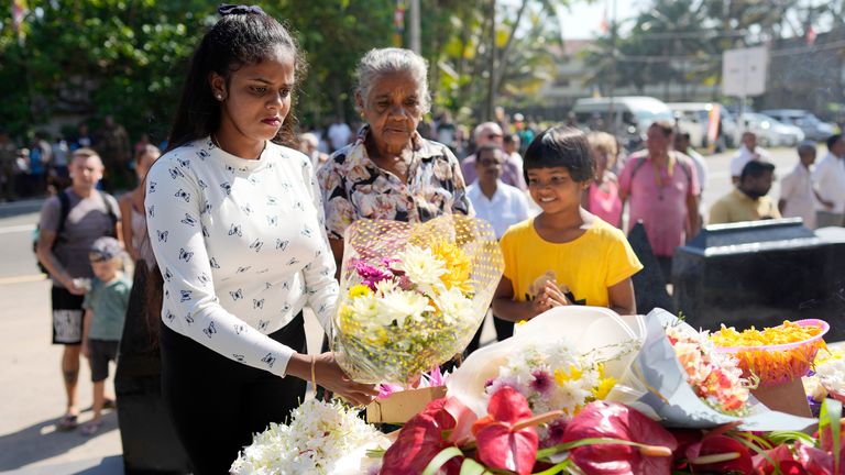 Relatives of tsunami victims offer tributes at a memorial in Peraliya, Sri Lanka.
Pic: AP
