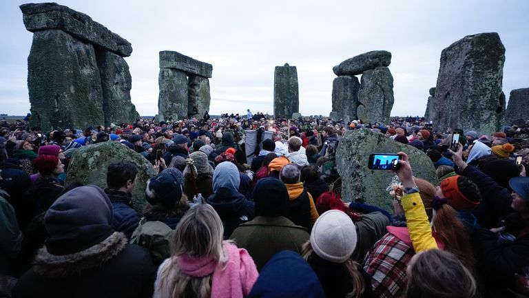 People take part in the winter solstice celebrations during sunrise at the Stonehenge prehistoric monument on Salisbury Plain in Wiltshire. Picture date: Saturday December 21, 2024.