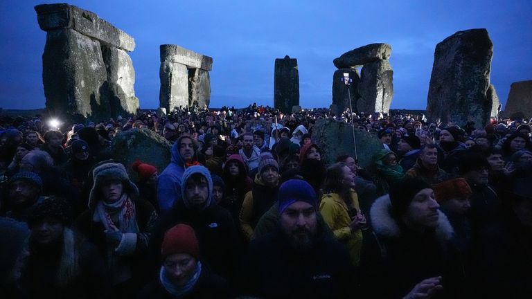 People take part in the winter solstice celebrations during sunrise at the Stonehenge prehistoric monument on Salisbury Plain in Wiltshire. Picture date: Saturday December 21, 2024.