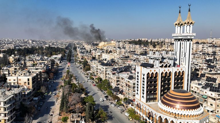 Smoke billows near residential buildings in a picture taken from a drone in Aleppo, Syria.
Pic: Reuters