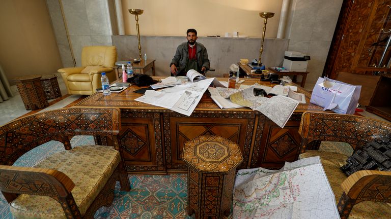 Syrian opposition fighters sit in the office of the presidential palace after the collapse of the Syrian government in Damascus, Syria, Sunday, December 8, 2024. (AP Photo/Omar Sanadiki)