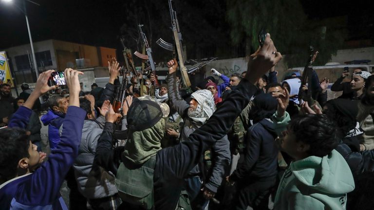 Syrian rebel fighters shout slogans against the late Assad regime in the Mazzeh district in Damascus Wednesday Dec. 25, 2024 (AP Photo/Omar Sanadiki)