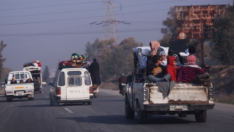 Residents leave Hama carrying their belongings. Pic: AP