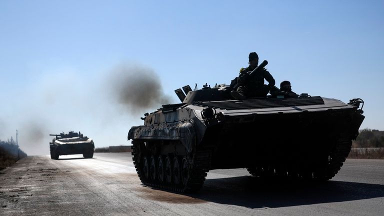 Syrian opposition fighters drive a seized seized Syrian army armoured vehicle near the town of Khan Assubul, Syria, southwest of Aleppo, Sunday, Dec. 1, 2024. Syrian opposition insurgency launched a campaign on Wednesday with a two-pronged attack on Aleppo and the countryside around Idlib.(AP Photo/Ghaith Alsayed)