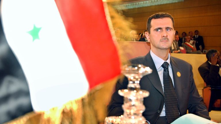 FILE - Syrian President Bashar al-Assad looks at his country's flag during the opening ceremony of the 16th regular session of the Arab Summit in Tunis, May 22, 2004. (AP Photo/Amr Nabil, File)