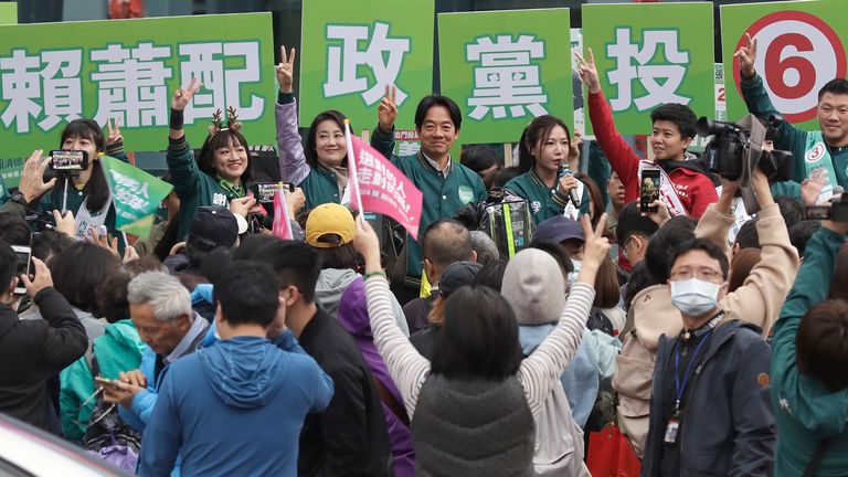 Taiwanese Vice President and Democratic Progressive Party presidential candidate William Lai, center, cheers to supporters with legislative candidates during an election campaign at the crossroads in Taipei, Taiwan, Wednesday, Jan. 3, 2024. Taiwan will hold its presidential election on Jan. 13, 2024. (AP Photo/Chiang Ying-ying)