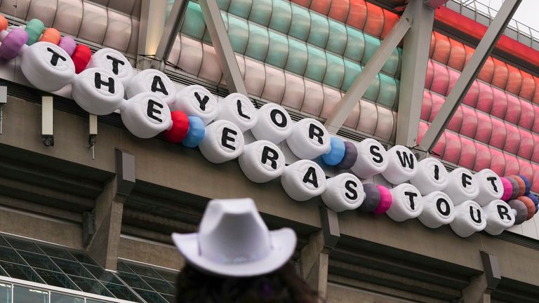 A concertgoer looks on at signage for Taylor Swift's "The Eras Tour" on Friday, Dec. 6, 2024, in Vancouver, British Columbia. (AP Photo/Lindsey Wasson)