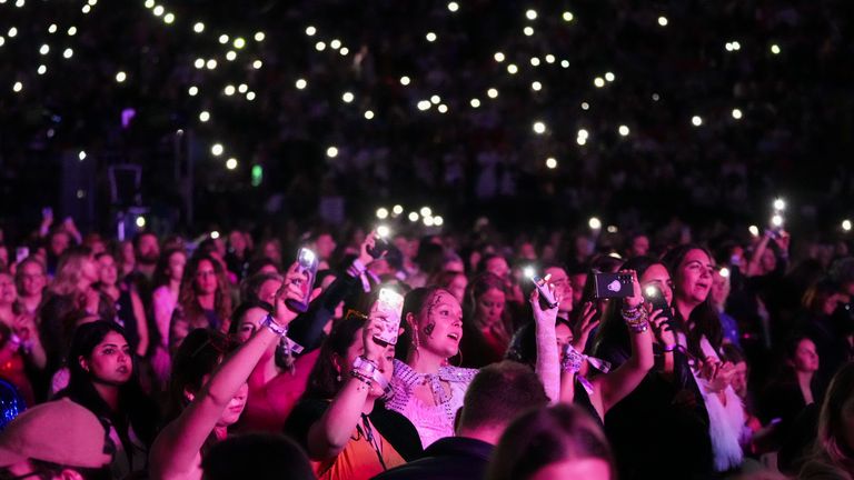 Concertgoers watch on during Taylor Swift's "The Eras Tour" on Friday, Dec. 6, 2024, in Vancouver, British Columbia. (AP Photo/Lindsey Wasson)