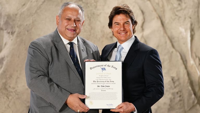 Actor Tom Cruise is presented with the US Navy Distinguished Public Service Award by US Secretary of the Navy, Carlos Del Toro, during a ceremony at Long Cross Studios in Chertsey, Surrey. Pic: Ian West/PA