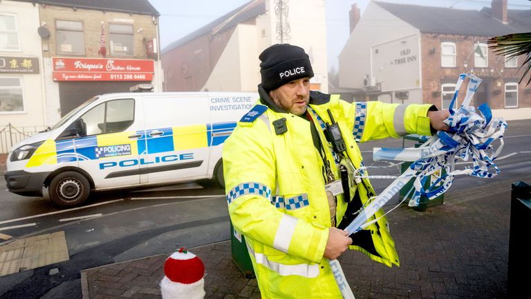 A police officer outside the Old Tree Inn pub in Kippax, where the quad hit a telegraph pole. Pic: PA