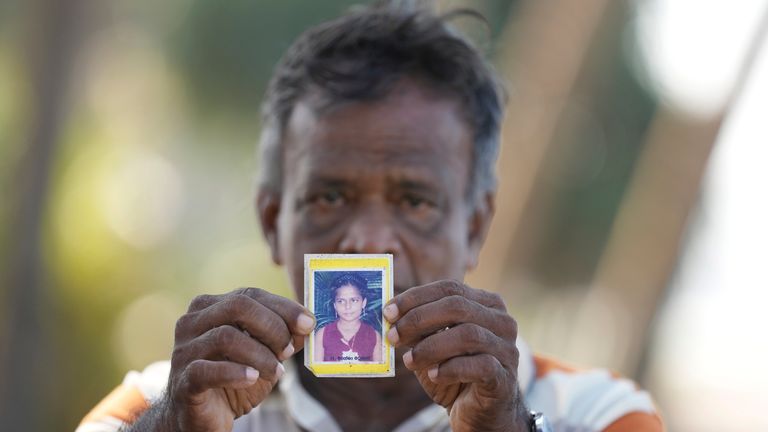 Dayaratne Halambage shows a portrait of his daughter who died during the 2004 Indian Ocean tsunami.
Pic: AP