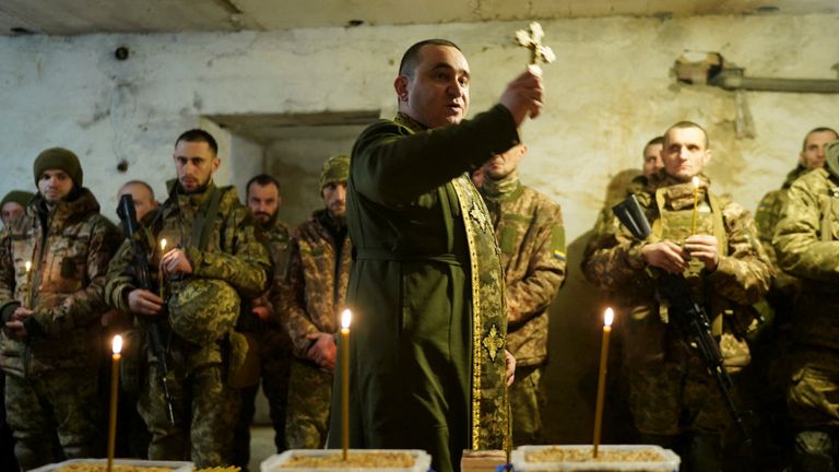 A military Orthodox chaplain conducts a Christmas Eve mass for service members of the 72nd Chorni Zaporozhtsi Separate Mechanized Brigade of the Ukrainian Armed Forces, amid Russia's attack on Ukraine, at a position in a front line in Donetsk region, Ukraine December 24, 2024. Valentyn Kuzan/Press Service of the 72nd Chorni Zaporozhtsi Separate Mechanized Brigade of the Ukrainian Armed Forces/Handout via REUTERS ATTENTION EDITORS - THIS IMAGE HAS BEEN SUPPLIED BY A THIRD PARTY.

