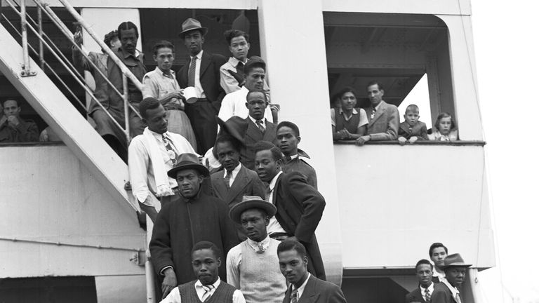 Jamaican men, mostly ex Royal Air Force servicemen, pose for a photo aboard the HMT Empire Windrush in 1948. Pic: AP