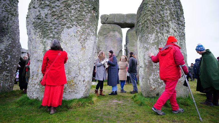 People take part in the winter solstice celebrations during sunrise at the Stonehenge prehistoric monument on Salisbury Plain in Wiltshire. Picture date: Thursday December 22, 2022.