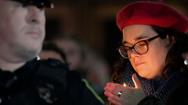 A supporter holds a candle during a candlelight vigil Tuesday, Dec. 17, 2024, outside the Wisconsin Capitol in Madison, Wis., following a shooting at the Abundant Life Christian School on Monday, Dec. 16. (AP Photo/Morry Gash)