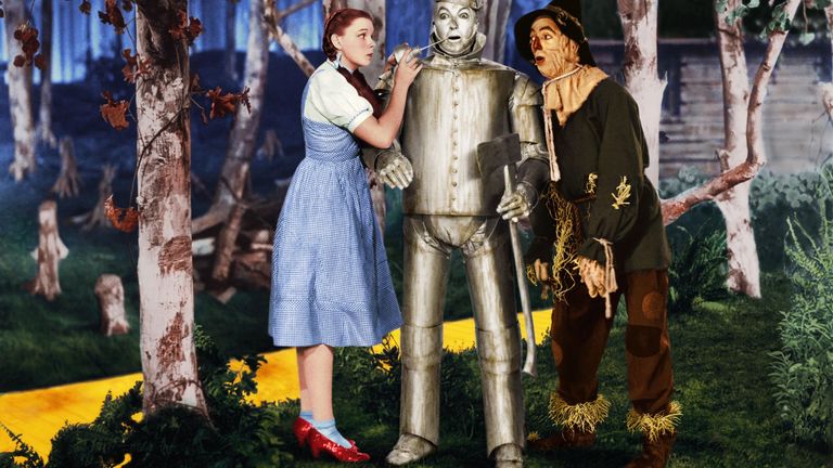 Dorothy wearing the red shoes in a scene from The Wizard Of Oz with the Tin Man and the Scarecrow. Pic: Rex Features