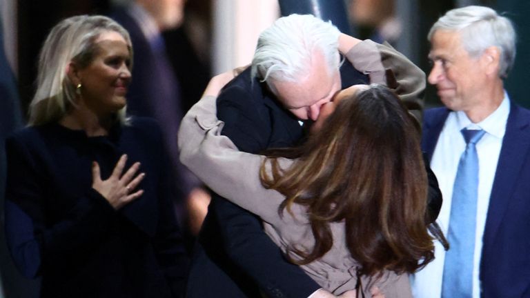 WikiLeaks founder Julian Assange kisses his wife Stella Assange as he arrives in Canberra, Australia, June 26, 2024. REUTERS/Edgar Su