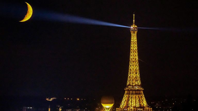 Paris 2024 Olympics - Paris, France - August 9, 2024
The moon is pictured with the Olympic cauldron and the Eiffel Tower REUTERS/Christian Hartmann          SEARCH "REUTERS BEST 2024" FOR THIS STORY. SEARCH "REUTERS YEAR-END" FOR ALL 2024 YEAR END GALLERIES.          TPX IMAGES OF THE DAY