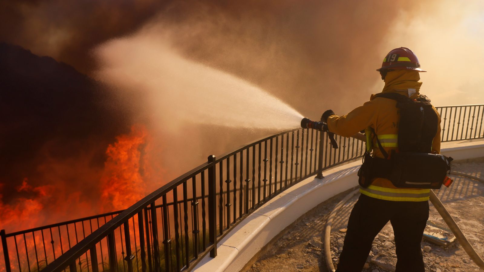 California firefighters battling wildfire sweeping exclusive Los Angeles hillside dotted with celebrity homes