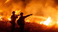 Firefighters battle the Hughes Fire near Castaic Lake.
Pic: Reuters