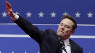 Elon Musk gestures at the podium inside the Capital One arena.
Pic: Reuters