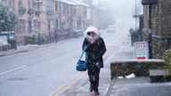A woman walks through heavy snowfall on the high street of Saddleworth.
Pic: AP