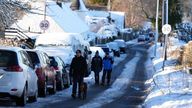 People walk through snow in Balerno, Edinburgh. The UK Health Security Agency (UKHSA) has issued cold weather health alerts for all of England ahead of a week of low temperatures. Amber alerts have been issued from 12pm on Thursday until January 8, meaning a rise in deaths, particularly among those aged 65 and over or with health conditions, is likely, the UKHSA said. Picture date: Friday January 3, 2025. PA Photo. Photo credit should read: Andrew Milligan/PA Wire 