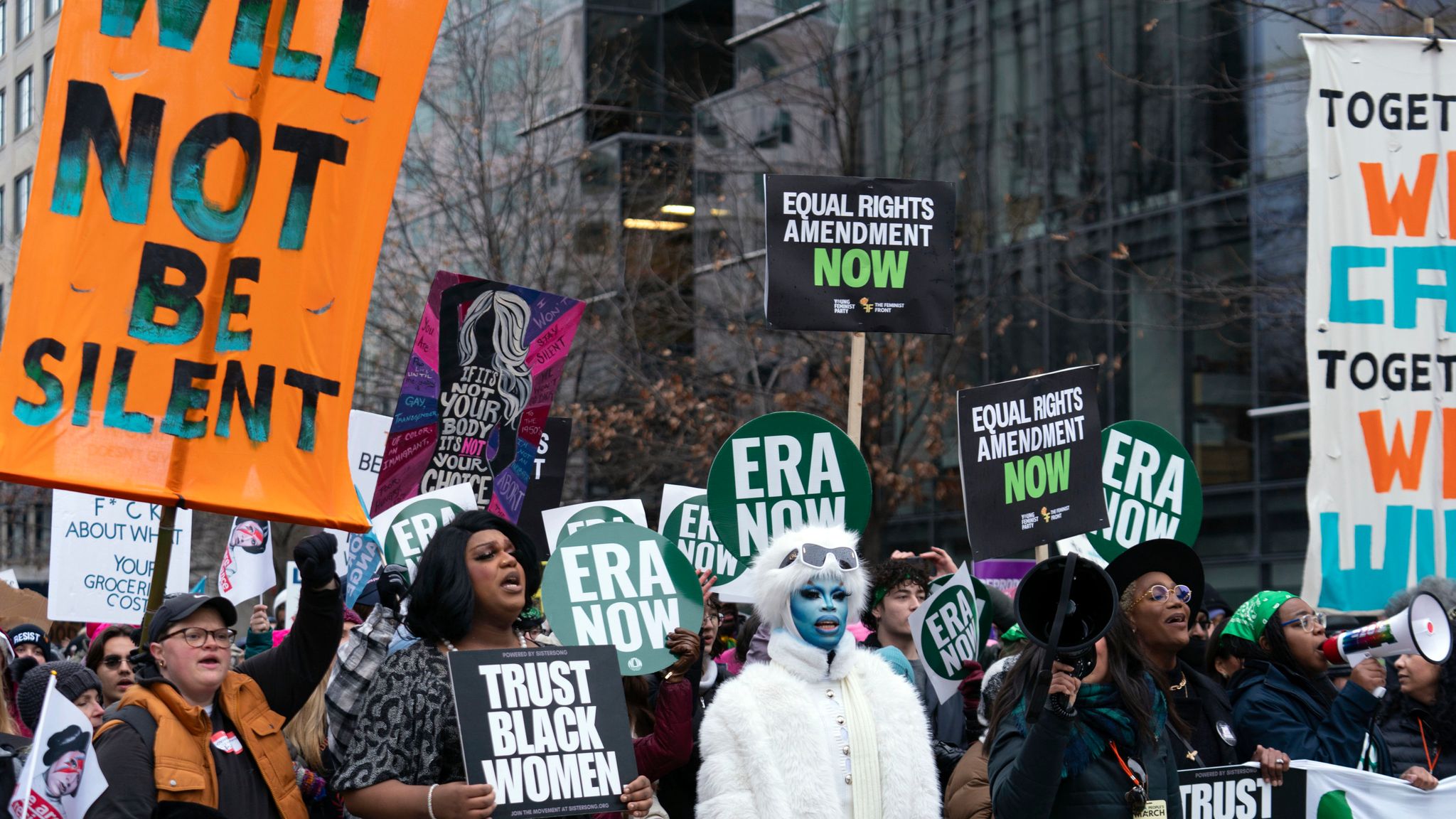 Thousands march in Washington DC as Trump heads back to capital for ...