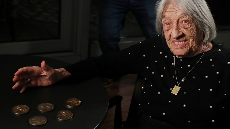 Agnes Keleti, former Olympic gold medal winning gymnast, gestures next to her next to her five gold medals in Budapest, Hungary Monday Jan. 4, 2021. The oldest living Olympic champion turns 100 and says the fondest memory of her remarkable life is simply that she has lived through it all. Keleti had her illustrious career interrupted by World War II and the subsequent cancellation of the 1940 and 1944 Olympics. (AP Photo/Laszlo Balogh)