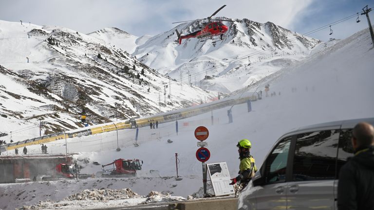 An emergency helicopter flies over the ski lifts at the Astum ski resort  on Saturday. Pic: AP