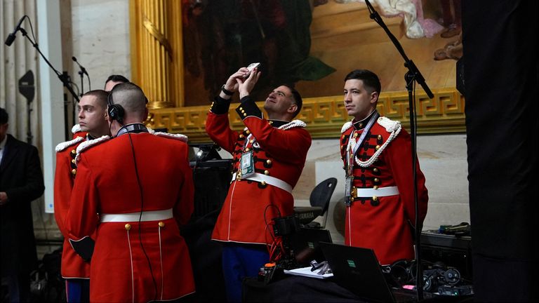 Members of the US Marine Band, The President's Own, arrive before the inauguration in the Rotunda of the U.S. Capitol. Pic: AP
