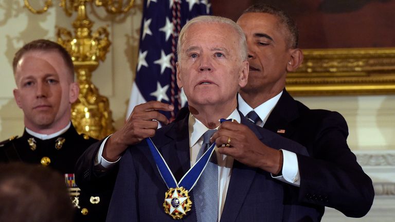 President Barack Obama presents Vice President Joe Biden with the Presidential Medal of Freedom during a ceremony in the State Dining Room of the White House in Washington, Jan. 12, 2017. (AP Photo/Susan Walsh)