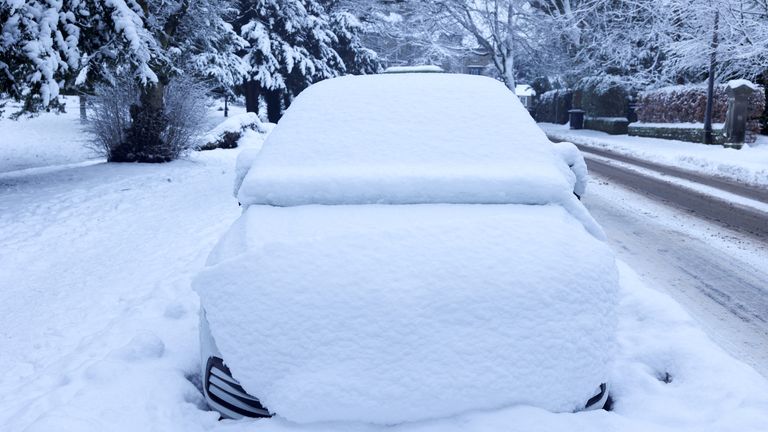 Snow blankets a vehicle in Buxton.
Pic: Reuters