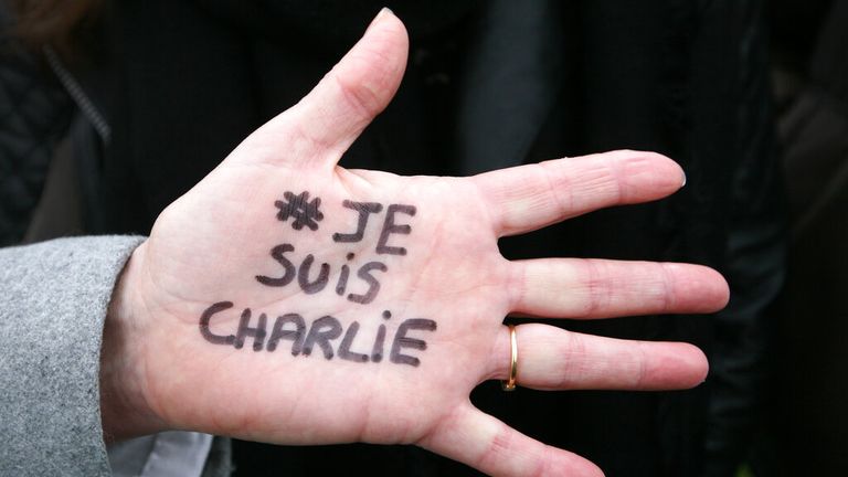 Brigitte Le Blein, of Nice, shows her hand reading "I am Charlie" during a silent march for victims of the shooting at the satirical newspaper Charlie Hebdo, Saturday, Jan. 10, 2015, in Nice, southeastern France. Ten journalists and two policemen were killed on Jan. 7 in a terrorist attack at the Charlie Hebdo headquarters in Paris. (AP Photo/Lionel Cironneau)


