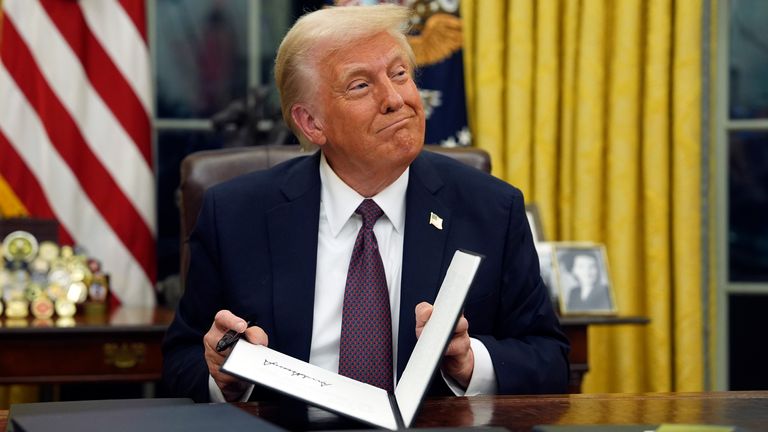 President Donald Trump signs executive orders in the Oval Office of the White House, Monday, Jan. 20, 2025, in Washington. (AP Photo/Evan Vucci)