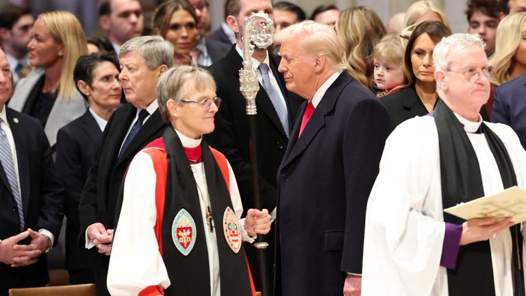 Donald Trump stands near Reverend Mariann Edgar Budde as he attends the National Day of Prayer Service.
Pic: Reuters