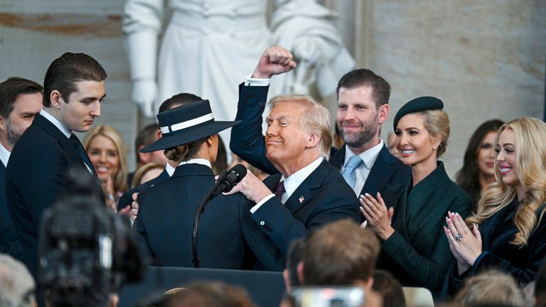 Members of the Trump family surround the new president as he is sworn in. Pic: AP